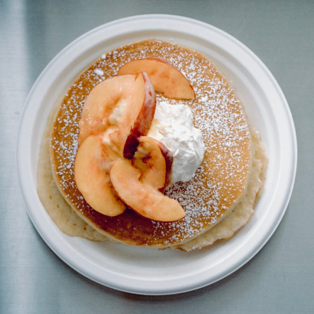 pancakes topped with peaches and cream